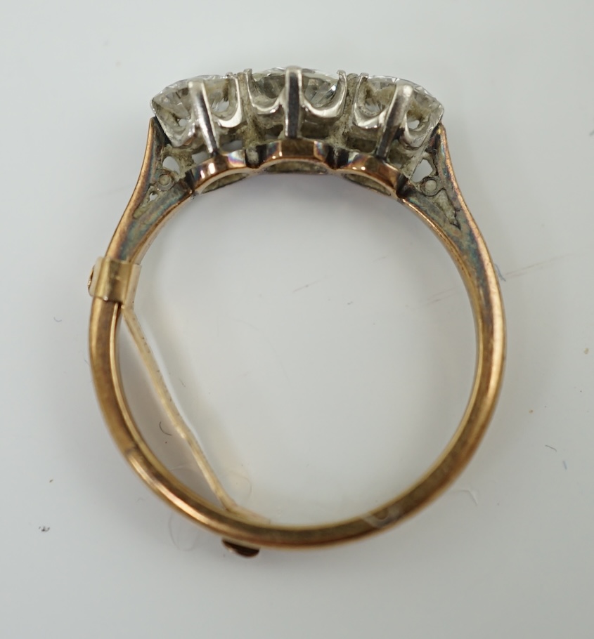 An 18ct gold, platinum and three stone diamond set ring